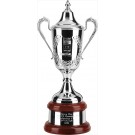 Fine English silverplated hand chased trophy cup and lid on mahogany plinth - 21" ht.